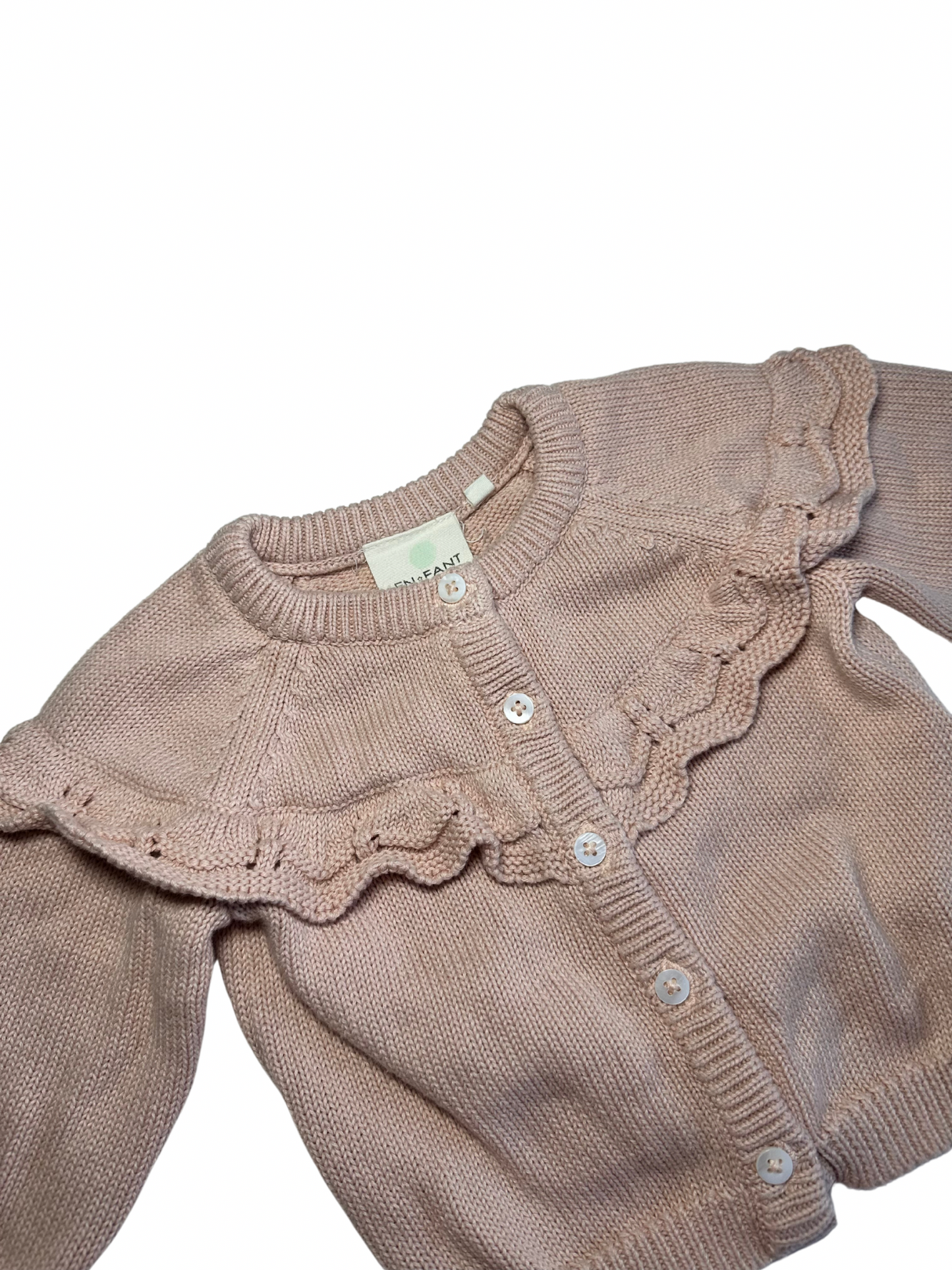 Lyserød cardigan med en flæse